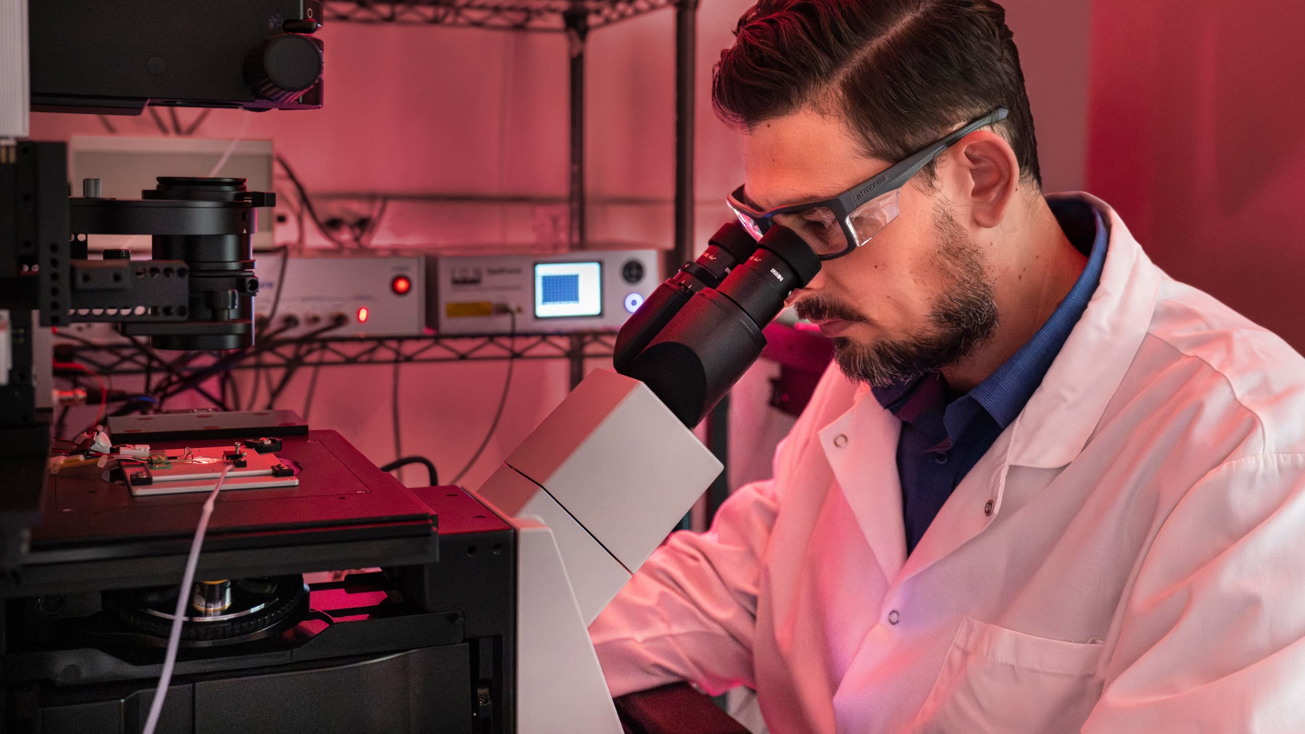 Scientist looking through microscope